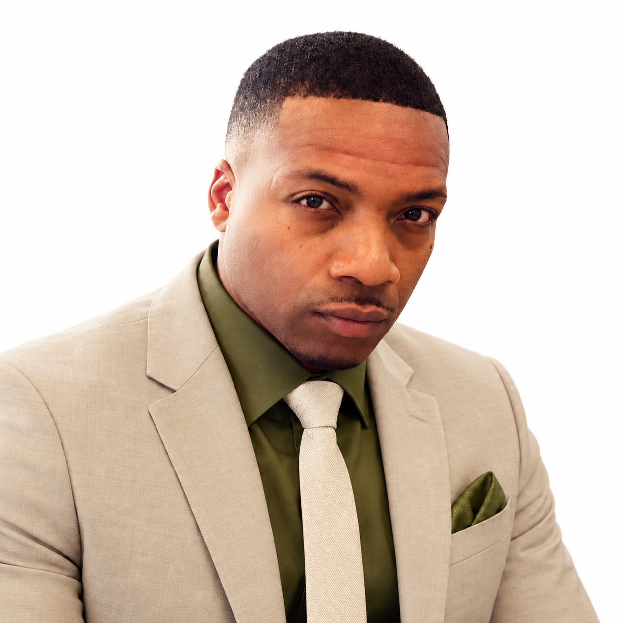 Lamont Robinson, founder of Robinsons Consultants LLC, wearing a beige blazer and tie with an olive green shirt